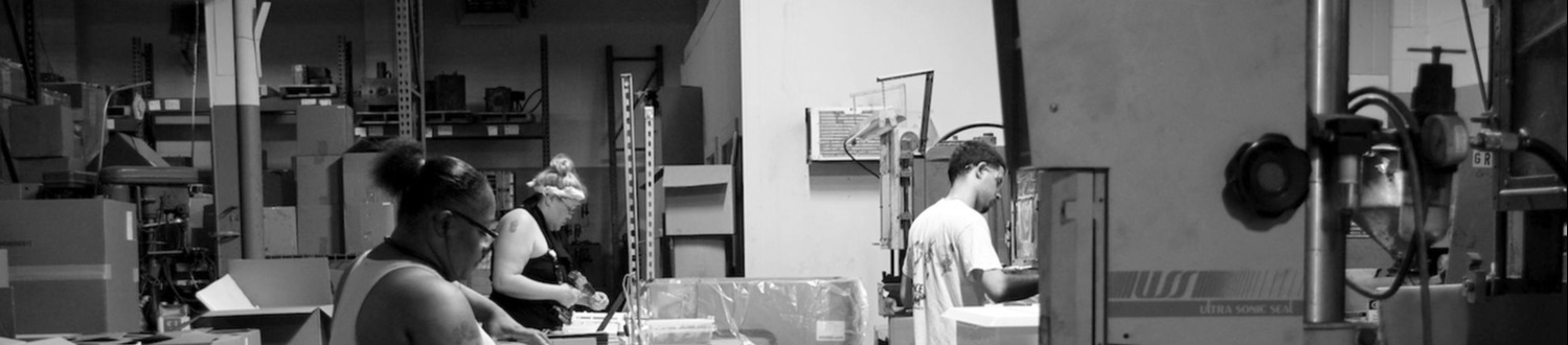 American workers processing injection molding pieces