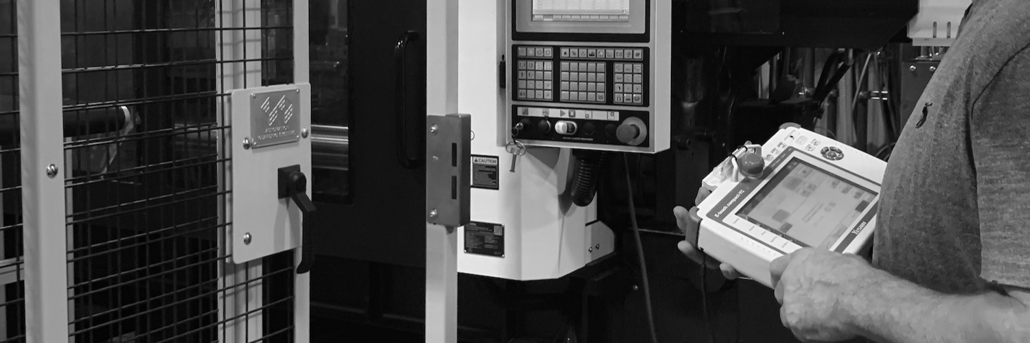 Process technician using controller at injection molding machine