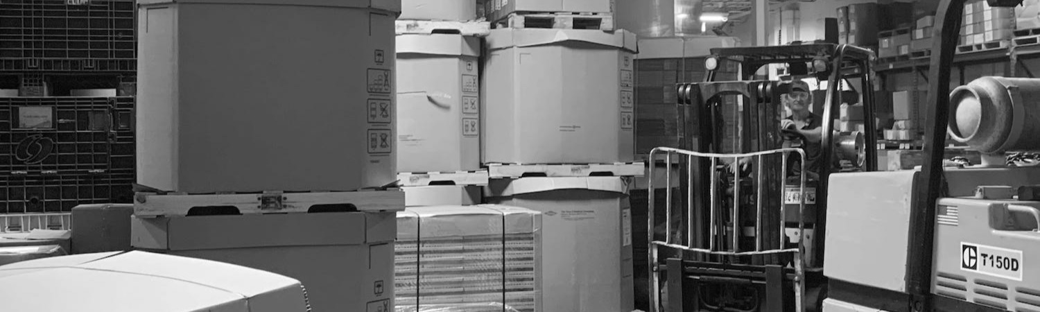 Production worker moving materials with a fork lift