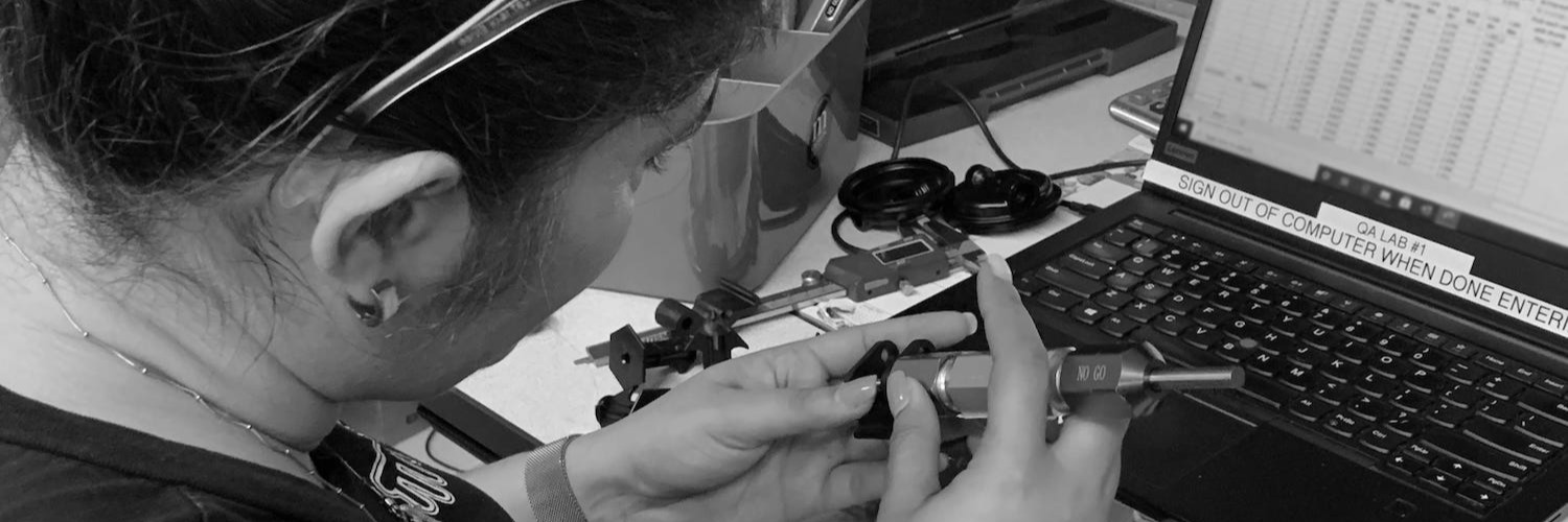 Quality technician inspecting finished molded parts