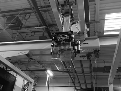 Injection molding robot with plastic bin