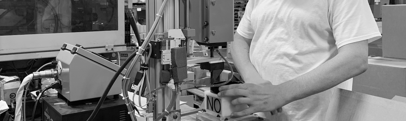 Worker at an Injection Molding Machine Making Parts