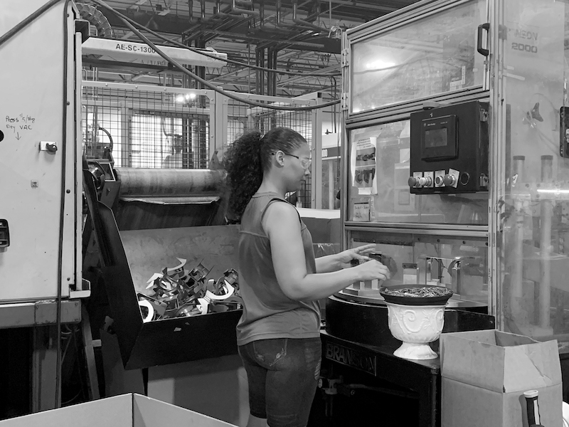 Female Molding Dynamics Press Operator At Her Machine Working